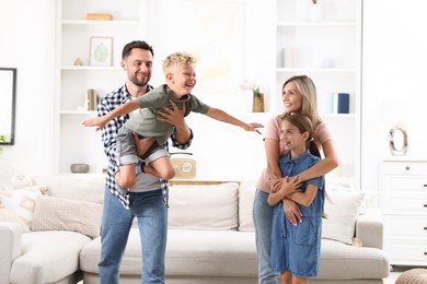 Photo of Happy family having fun in light room