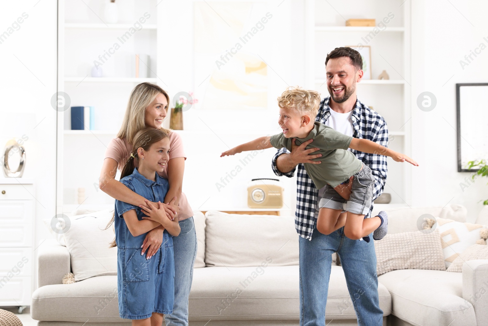 Photo of Happy family having fun in light room