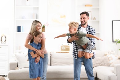 Photo of Happy family having fun in light room