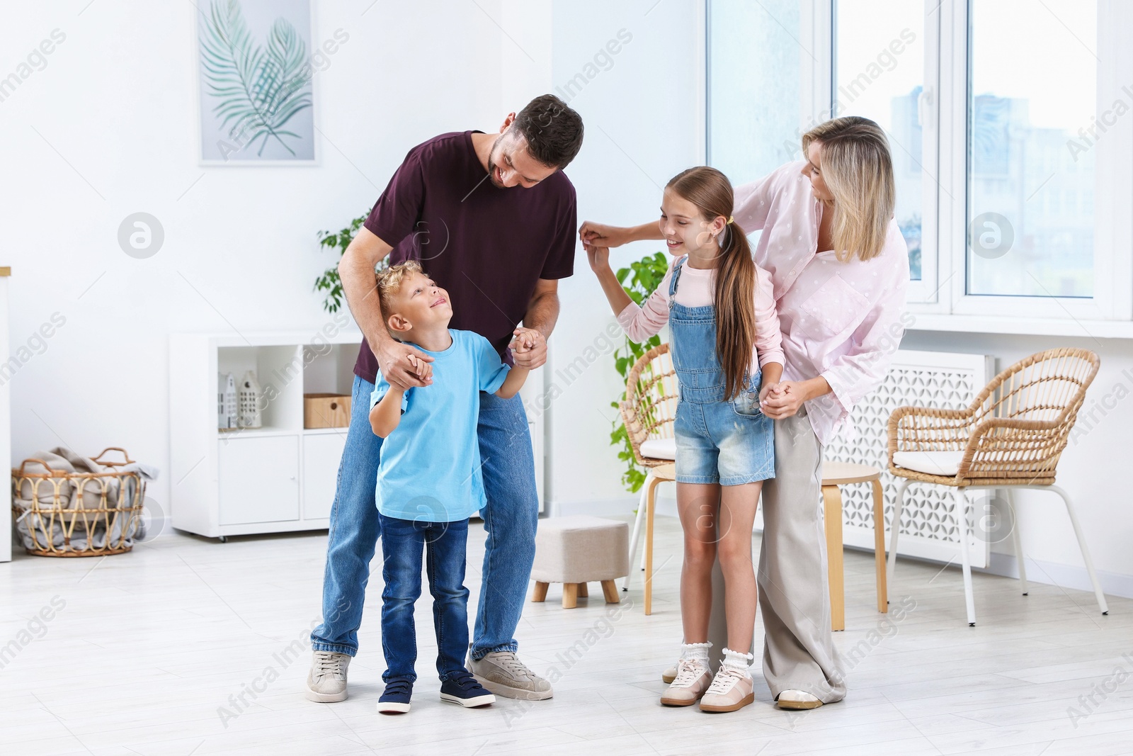 Photo of Happy family spending time together in light room