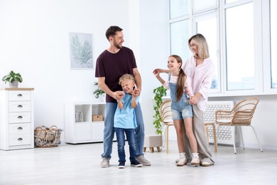 Photo of Happy family spending time together in light room