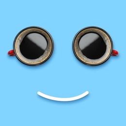 Image of Coffee in cups and line making smiling face on light blue background, top view
