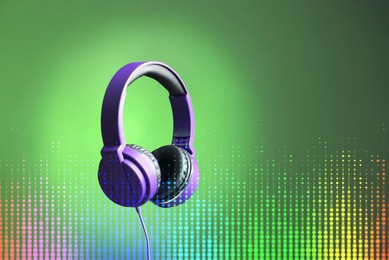 Image of Headphones and sound waves against green gradient background