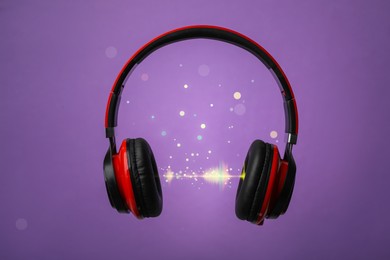 Image of Headphones and sound waves against purple background