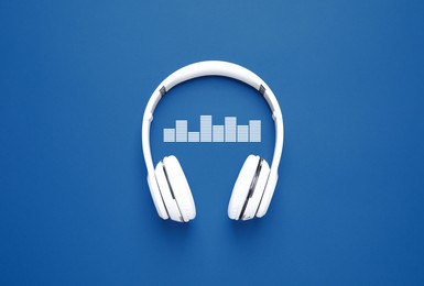 Image of Headphones and sound waves on blue background, top view