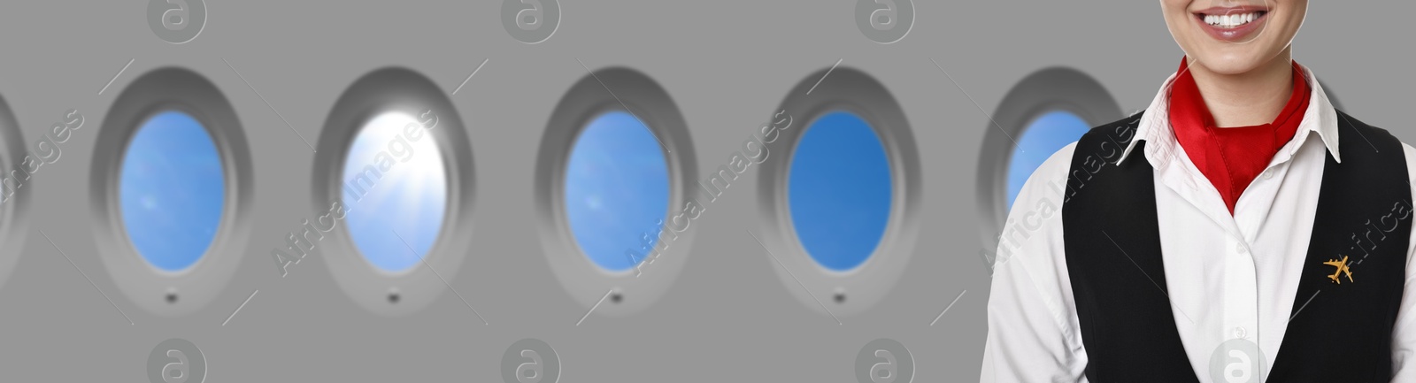 Image of Air hostess smiling near windows in plane, closeup