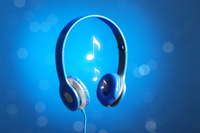 Image of Headphones and music notes against blue gradient background