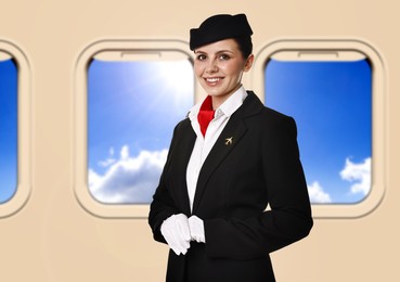 Image of Air hostess smiling near windows in plane