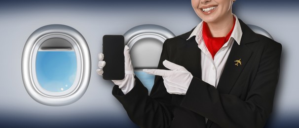 Image of Air hostess pointing at mobile phone near windows in plane, closeup
