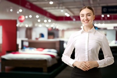 Image of Young hostess smiling in furniture store. Space for text