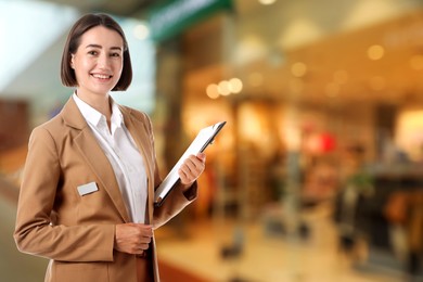 Image of Young hostess with clipboard near boutique. Space for text