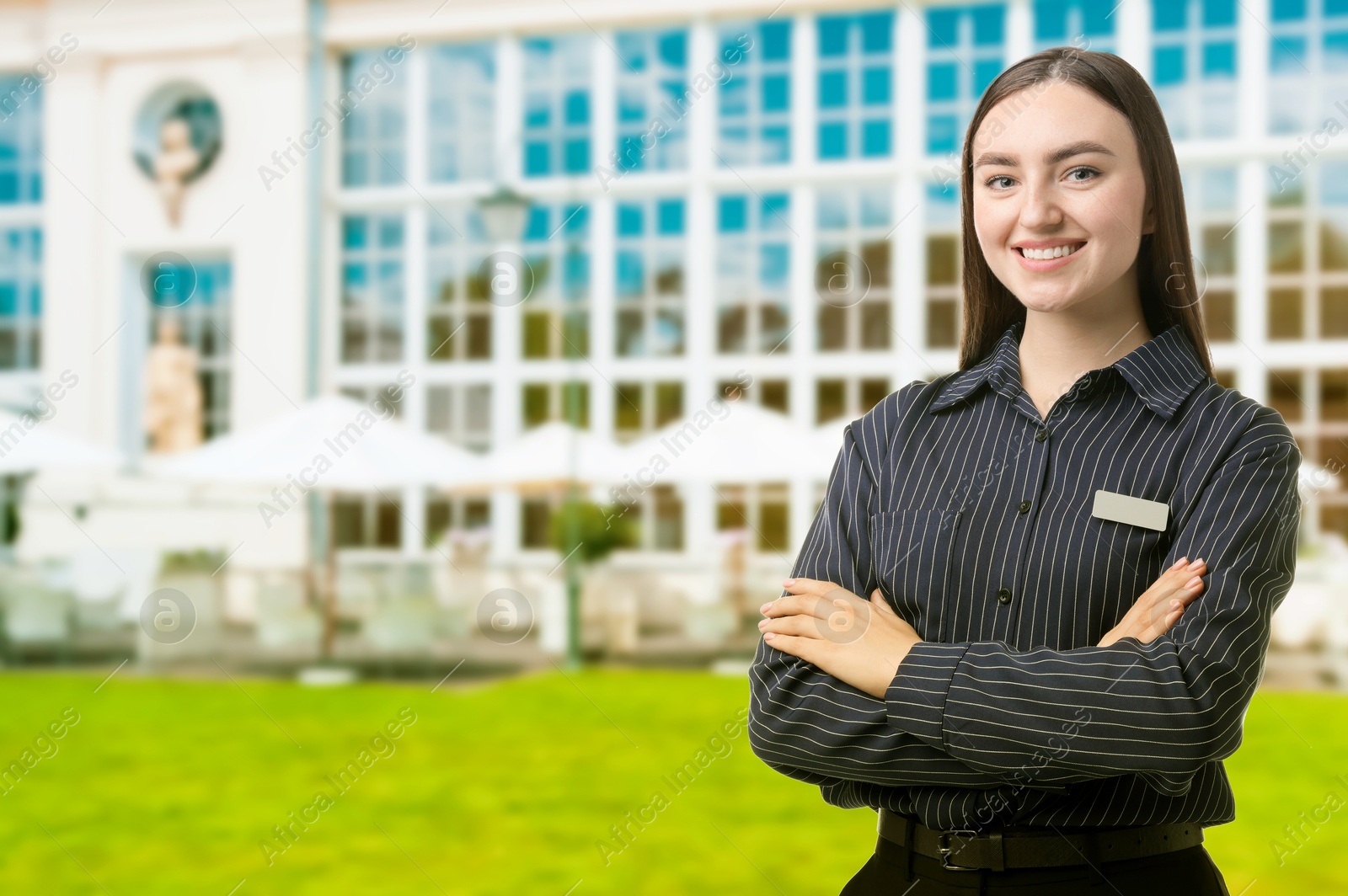 Young hostess near hotel outdoors. Space for text Image of Young hostess near hotel outdoors. Space for text