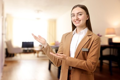 Image of Young hostess welcoming to hotel room. Space for text