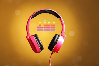 Image of Headphones and sound waves against orange gradient background