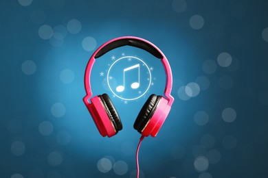 Image of Headphones and music note against blue gradient background