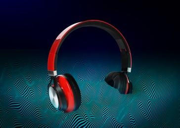 Image of Headphones drowning in sound waves against gradient background