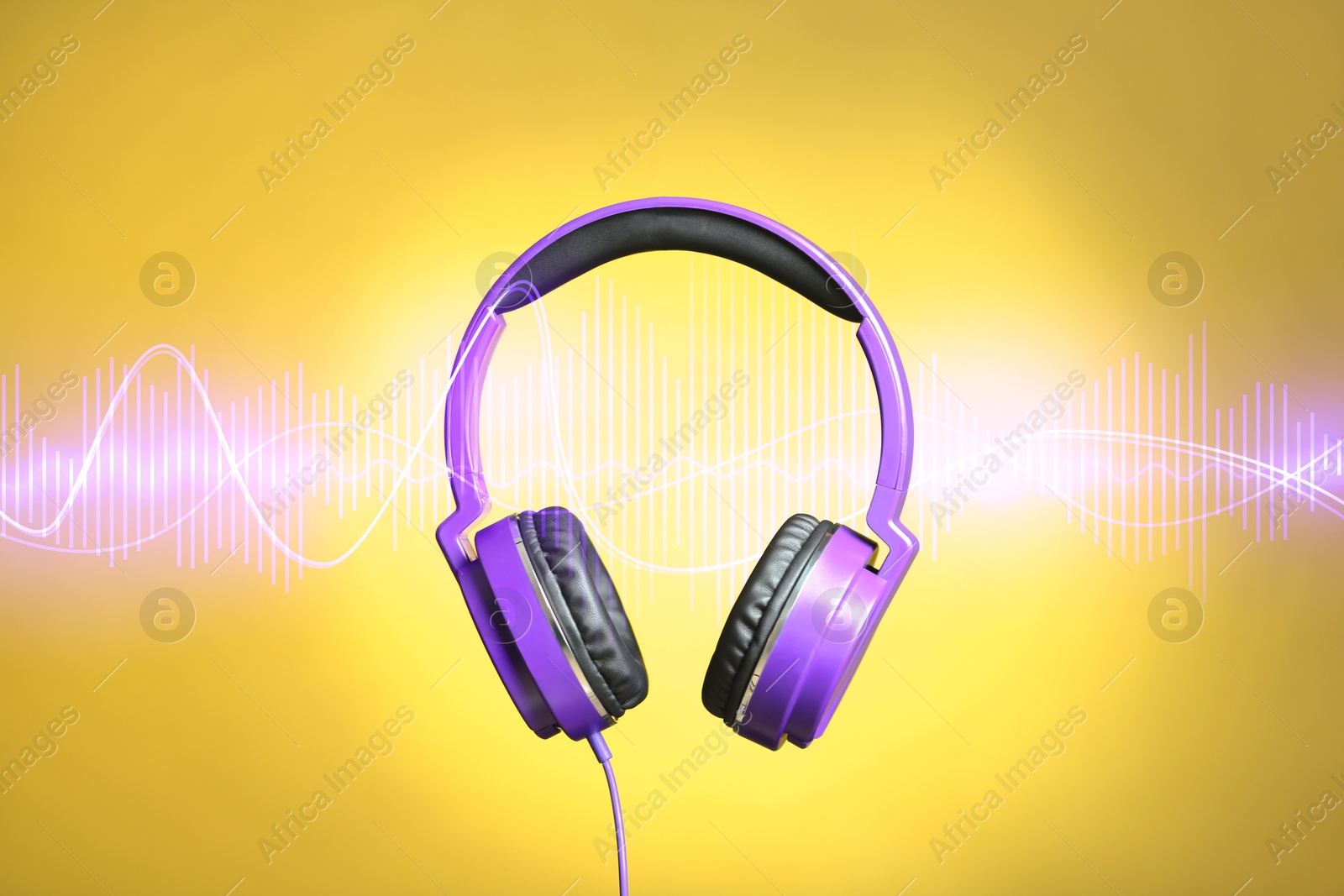 Image of Headphones and sound waves against yellow gradient background
