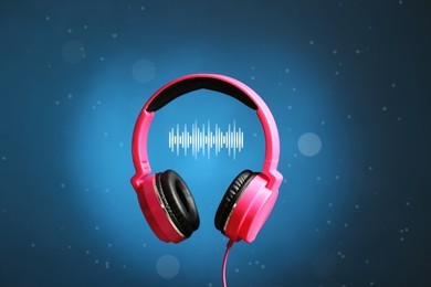 Image of Headphones and sound waves against blue gradient background