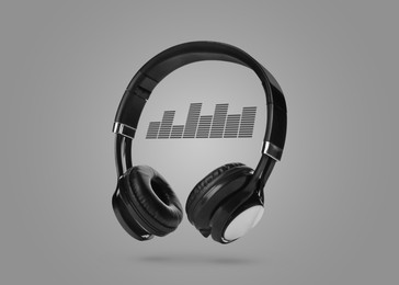 Image of Headphones and sound waves against grey background