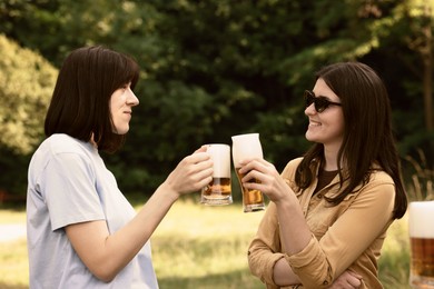 Photo of Young women with glasses of beer outdoors
