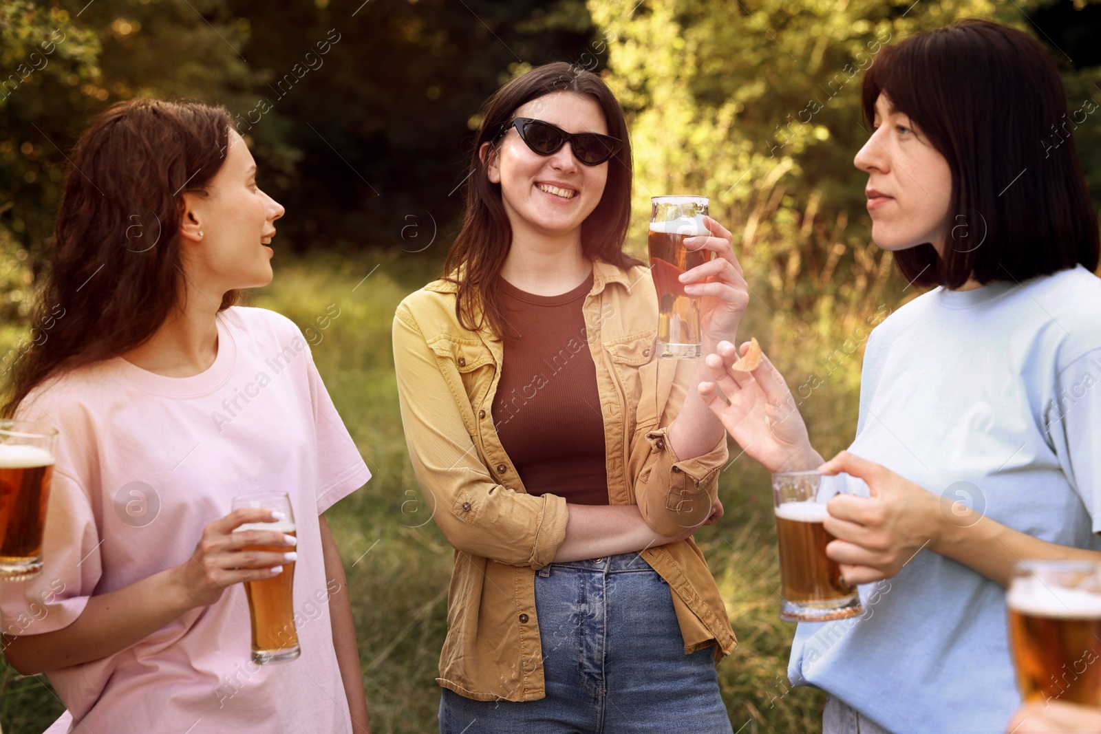 Group of happy friends having fun and drinking beer outdoors Photo of Group of happy friends having fun and drinking beer outdoors