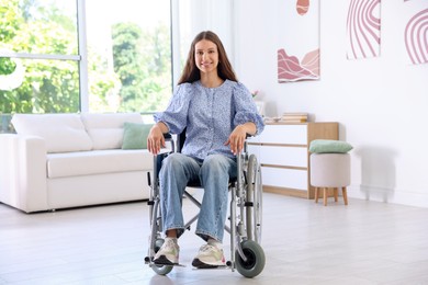 Photo of Smiling teenage girl in wheelchair at home