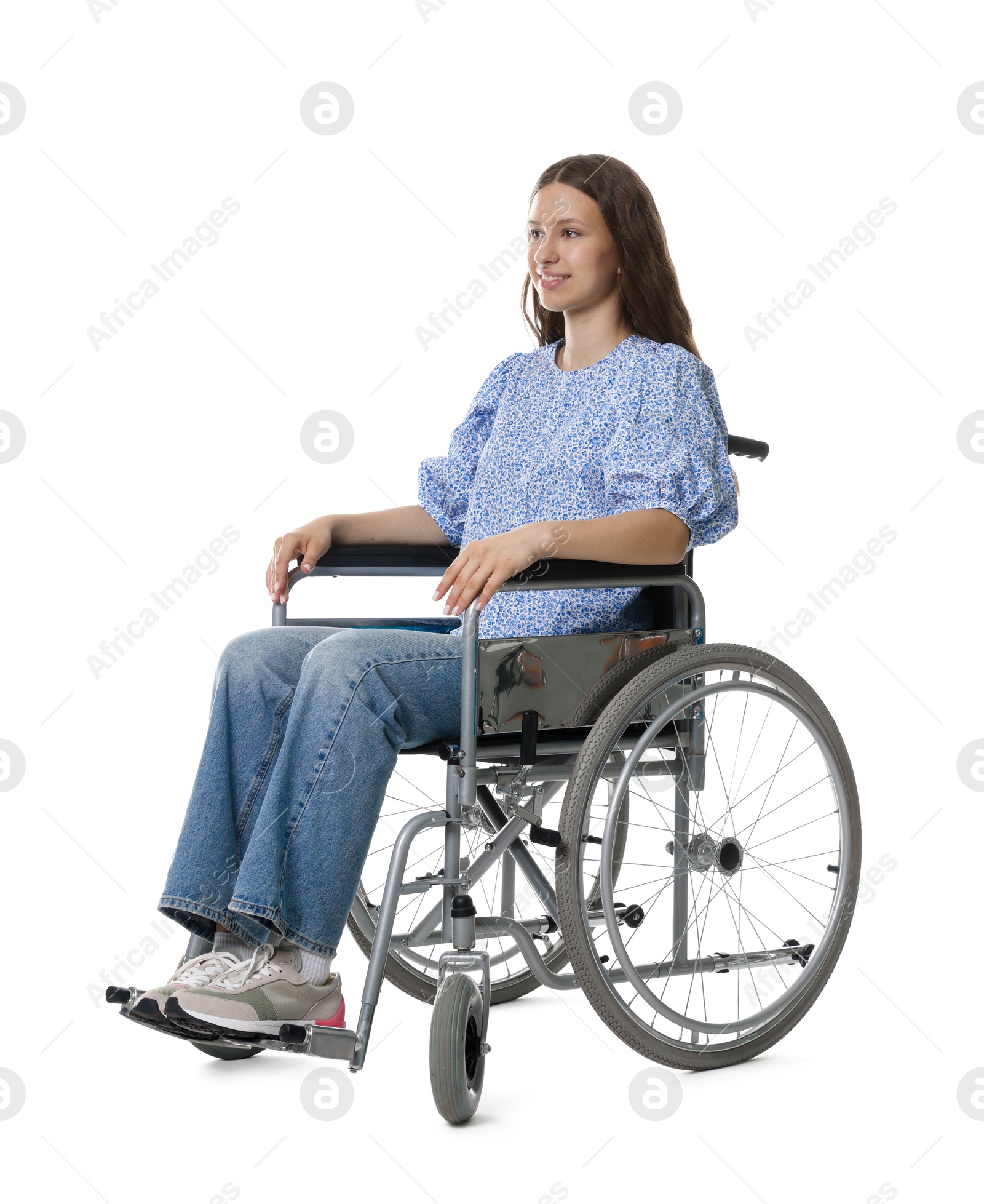 Photo of Smiling teenage girl in wheelchair on white background