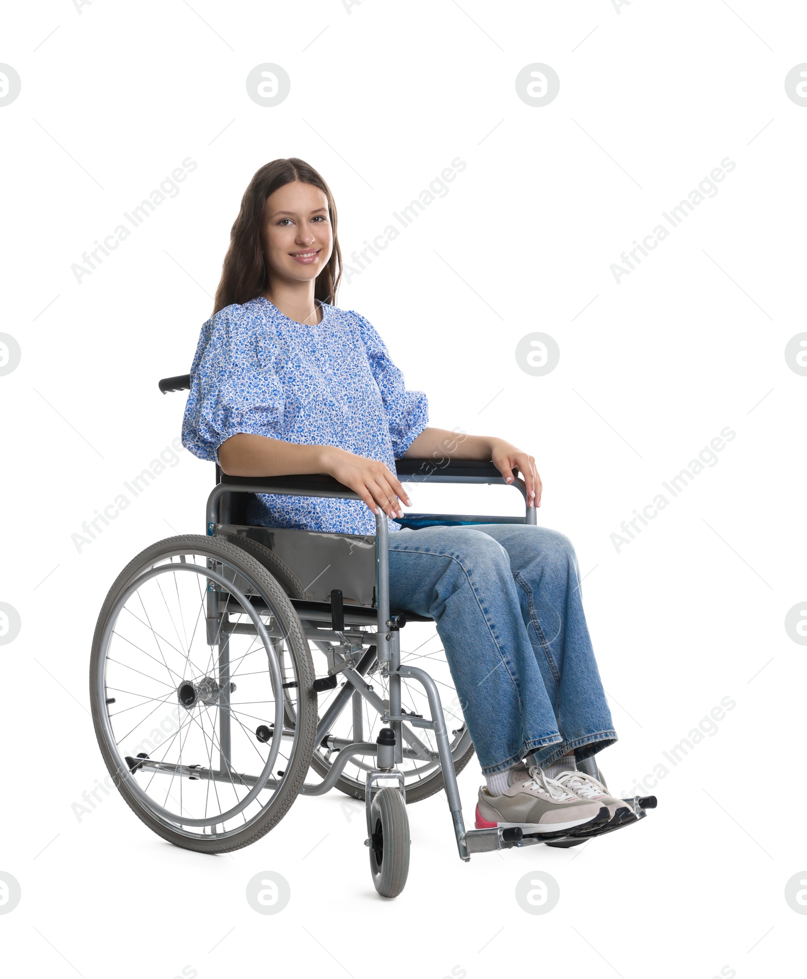 Photo of Smiling teenage girl in wheelchair on white background
