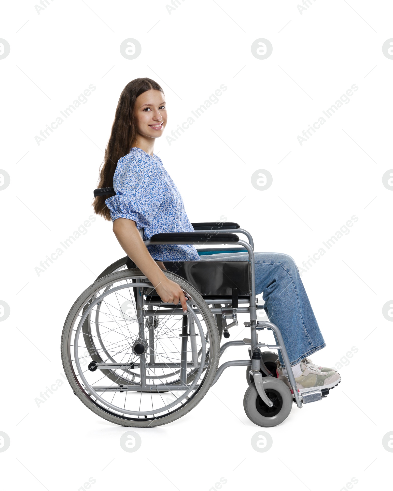 Photo of Smiling teenage girl in wheelchair on white background