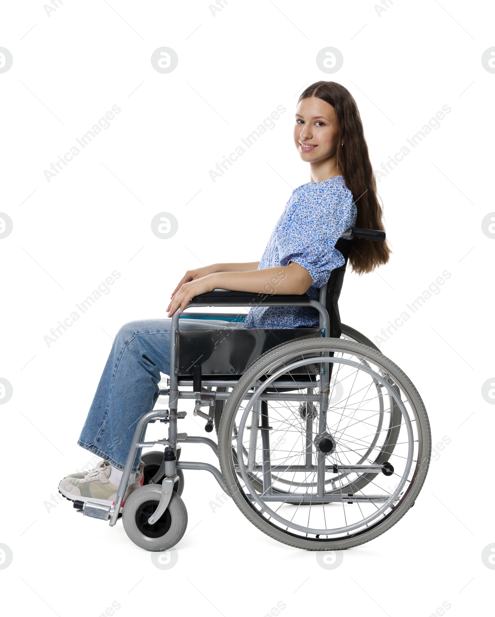 Photo of Smiling teenage girl in wheelchair on white background