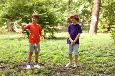 Photo of Cute little kids having fun with soap bubbles in park