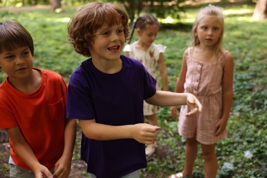 Photo of Cute little kids spending time together in park, selective focus