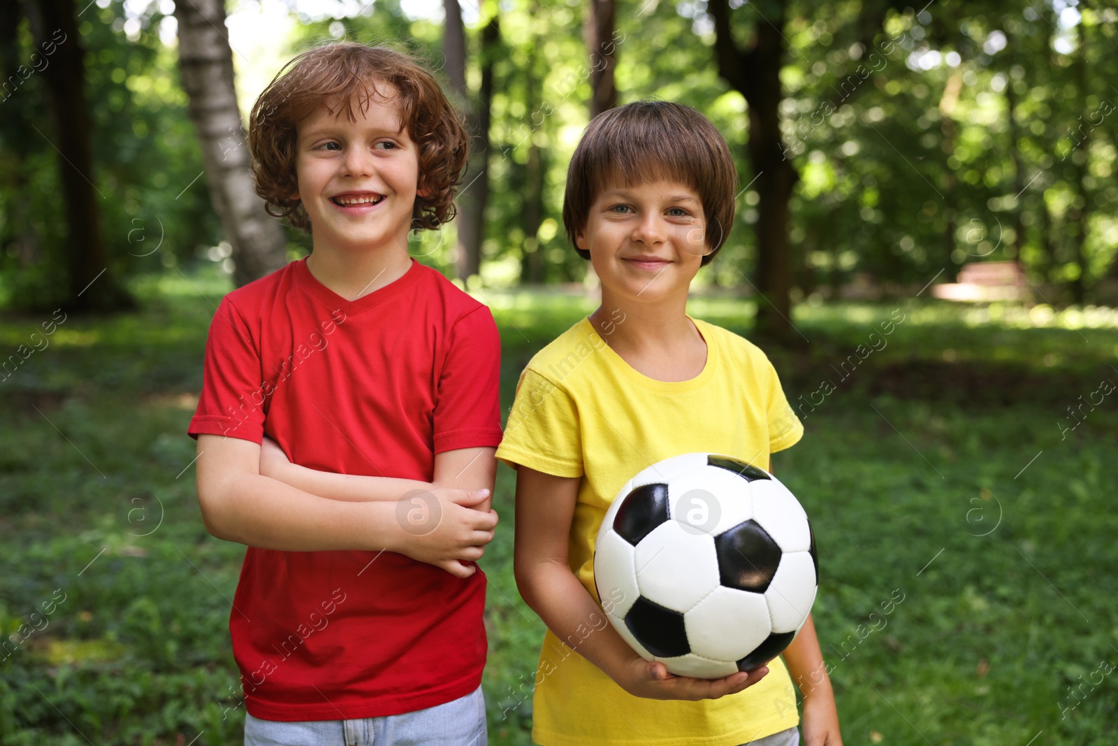 Photo of Cute little kids with soccer ball in park