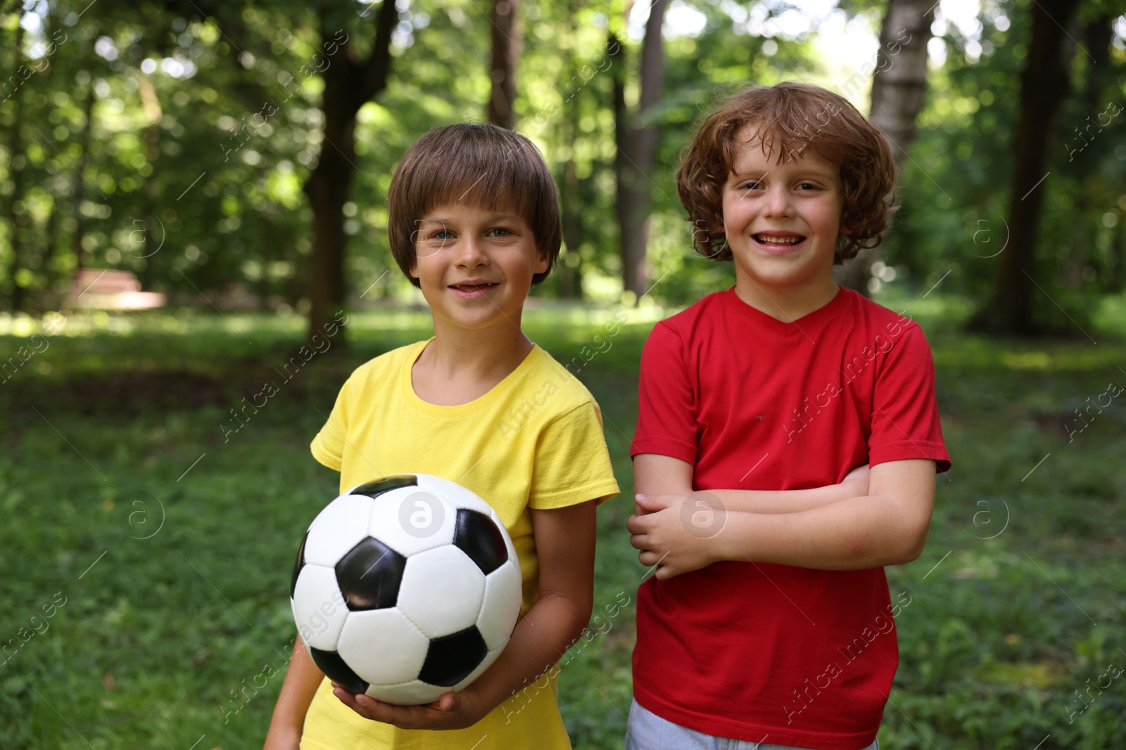 Photo of Cute little kids with soccer ball in park