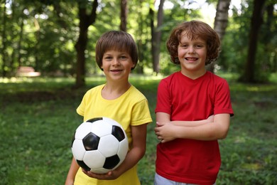 Photo of Cute little kids with soccer ball in park