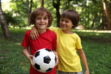 Photo of Cute little kids with soccer ball in park