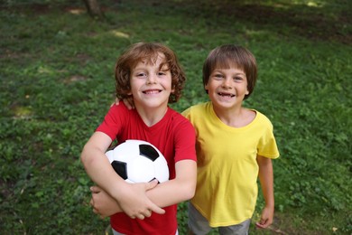 Photo of Cute little kids with soccer ball in park