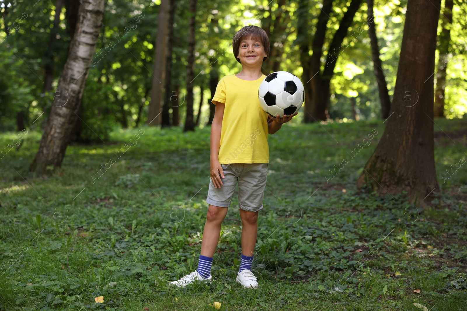 Photo of Cute little boy with soccer ball in park
