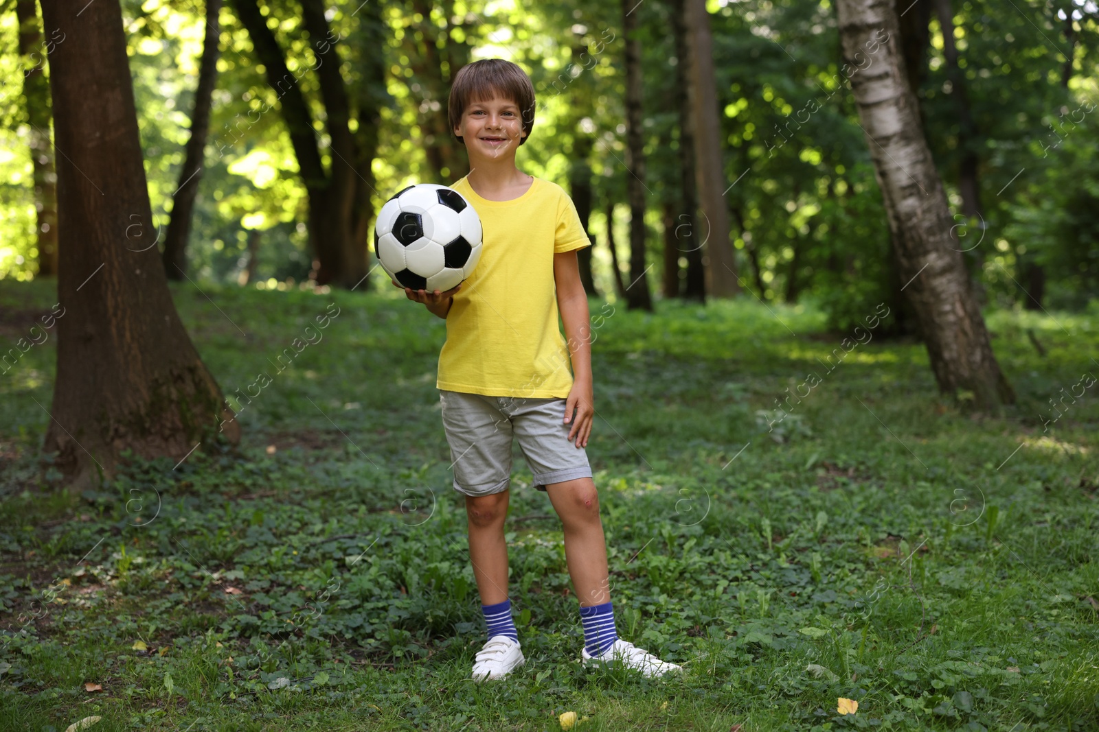 Photo of Cute little boy with soccer ball in park