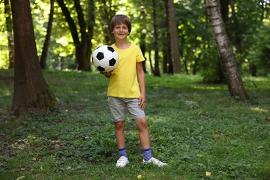 Photo of Cute little boy with soccer ball in park