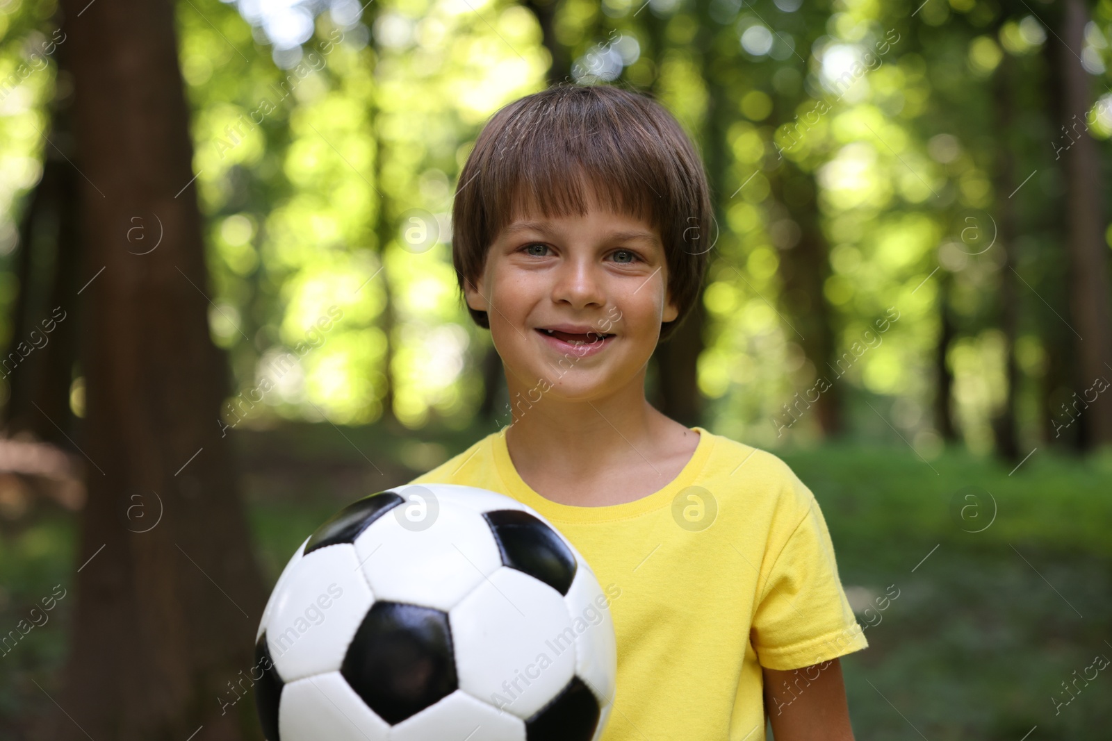 Photo of Cute little boy with soccer ball in park
