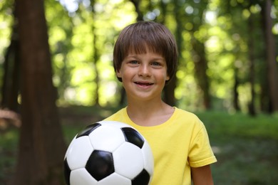 Photo of Cute little boy with soccer ball in park