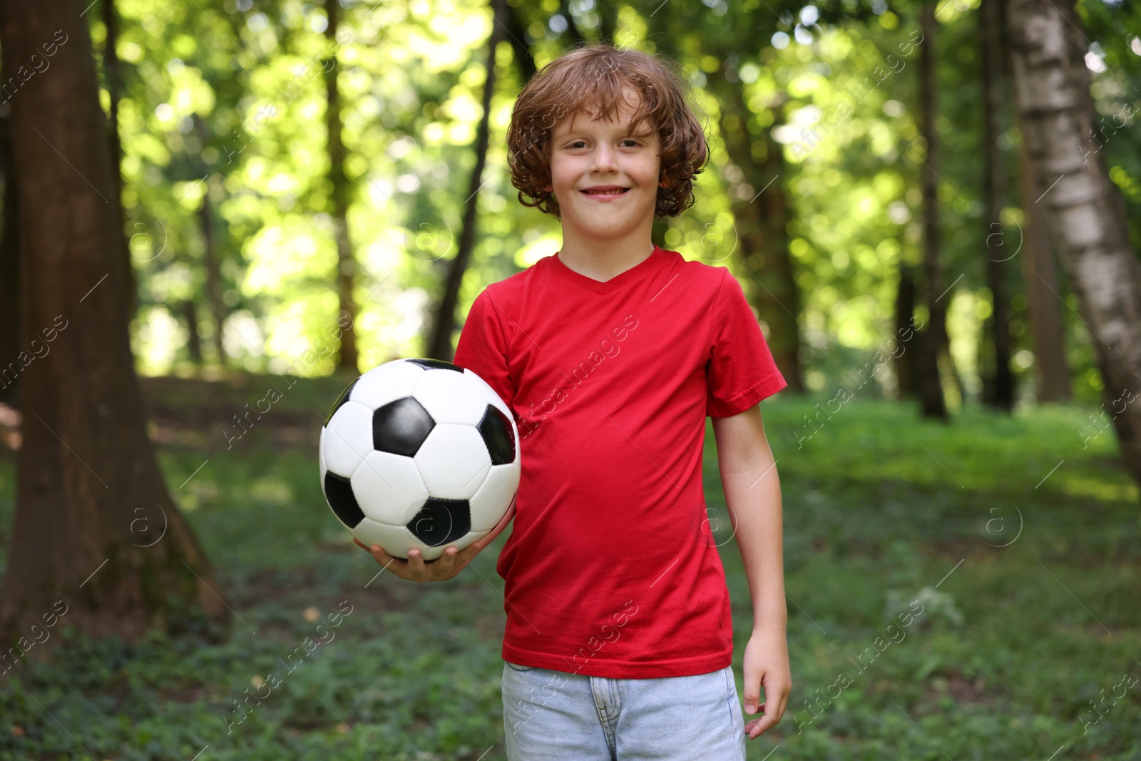 Photo of Cute little boy with soccer ball in park