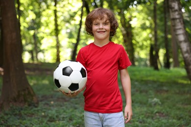 Photo of Cute little boy with soccer ball in park