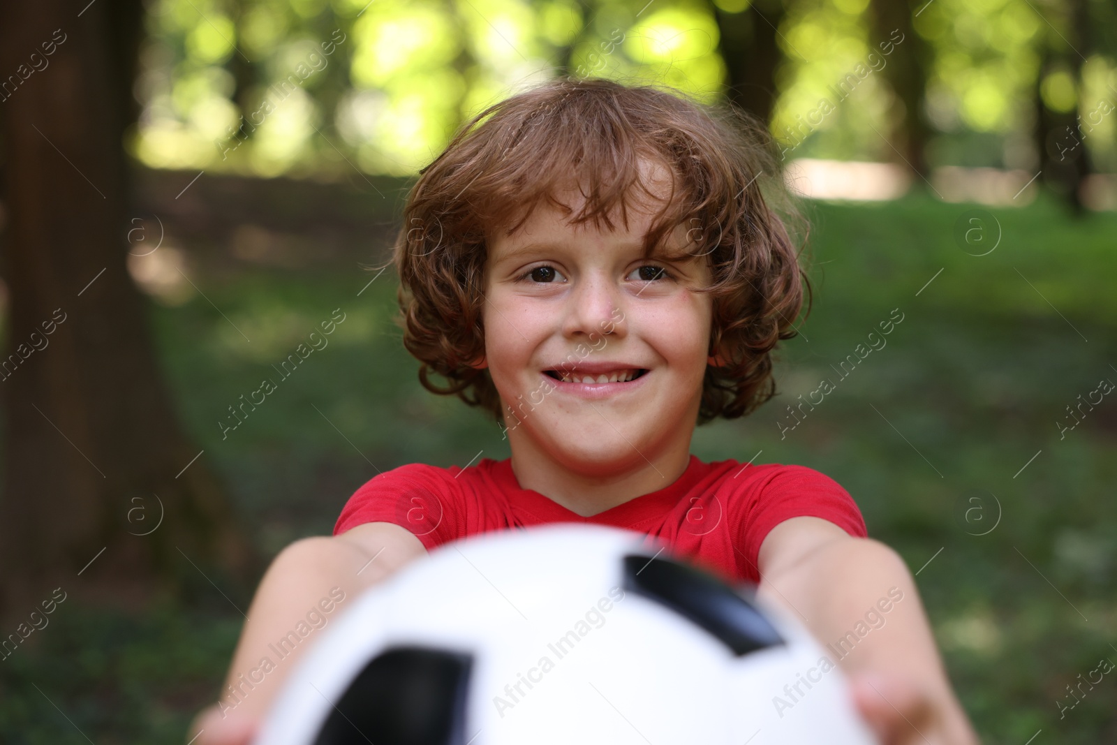 Photo of Cute little boy with soccer ball in park