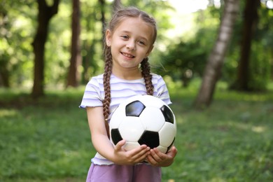 Photo of Cute little girl with soccer ball in park