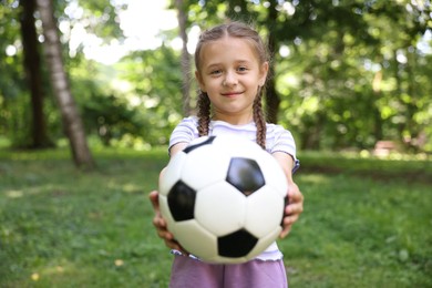 Photo of Cute little girl with soccer ball in park