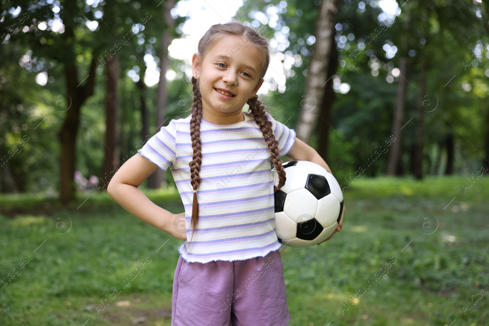 Photo of Cute little girl with soccer ball in park