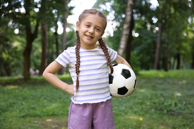 Photo of Cute little girl with soccer ball in park