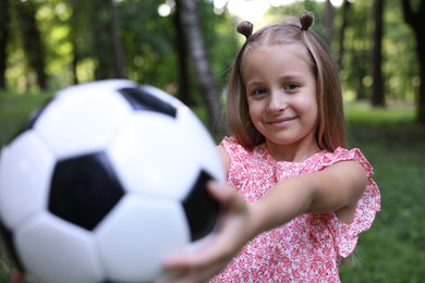 Photo of Cute little girl with soccer ball in park